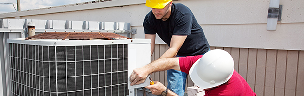 men repairing an HVAC system